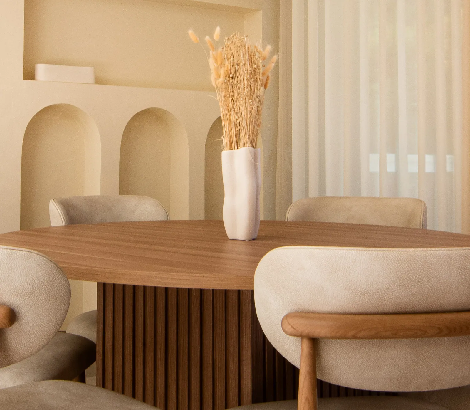 Round dining table beneath arched niches