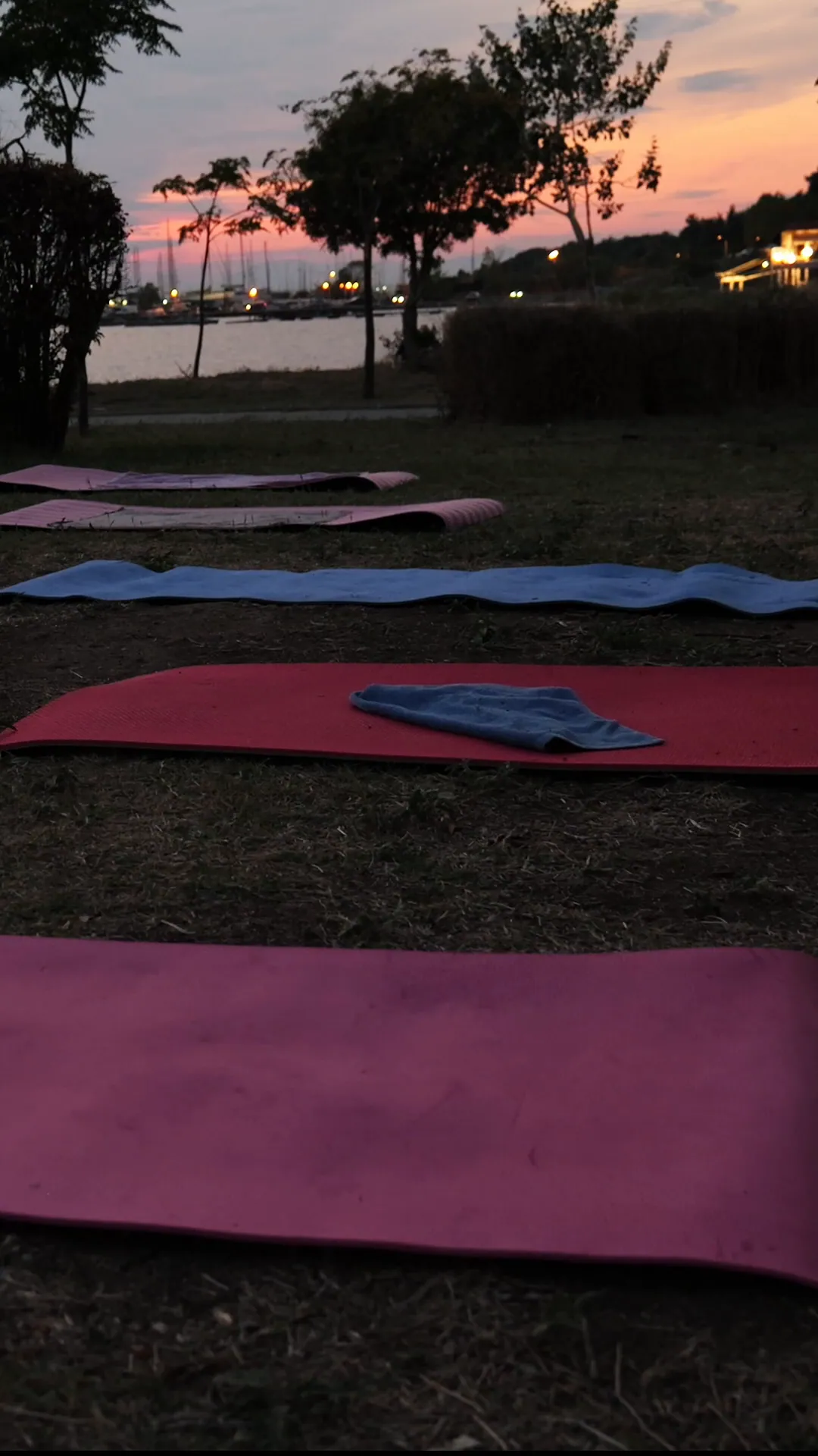 Mats on the grass as the light fades